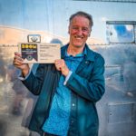 Our founder holding our award